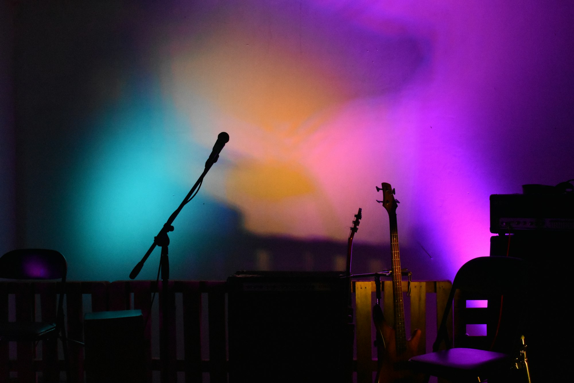 Microphone on a stage washed in coloured light